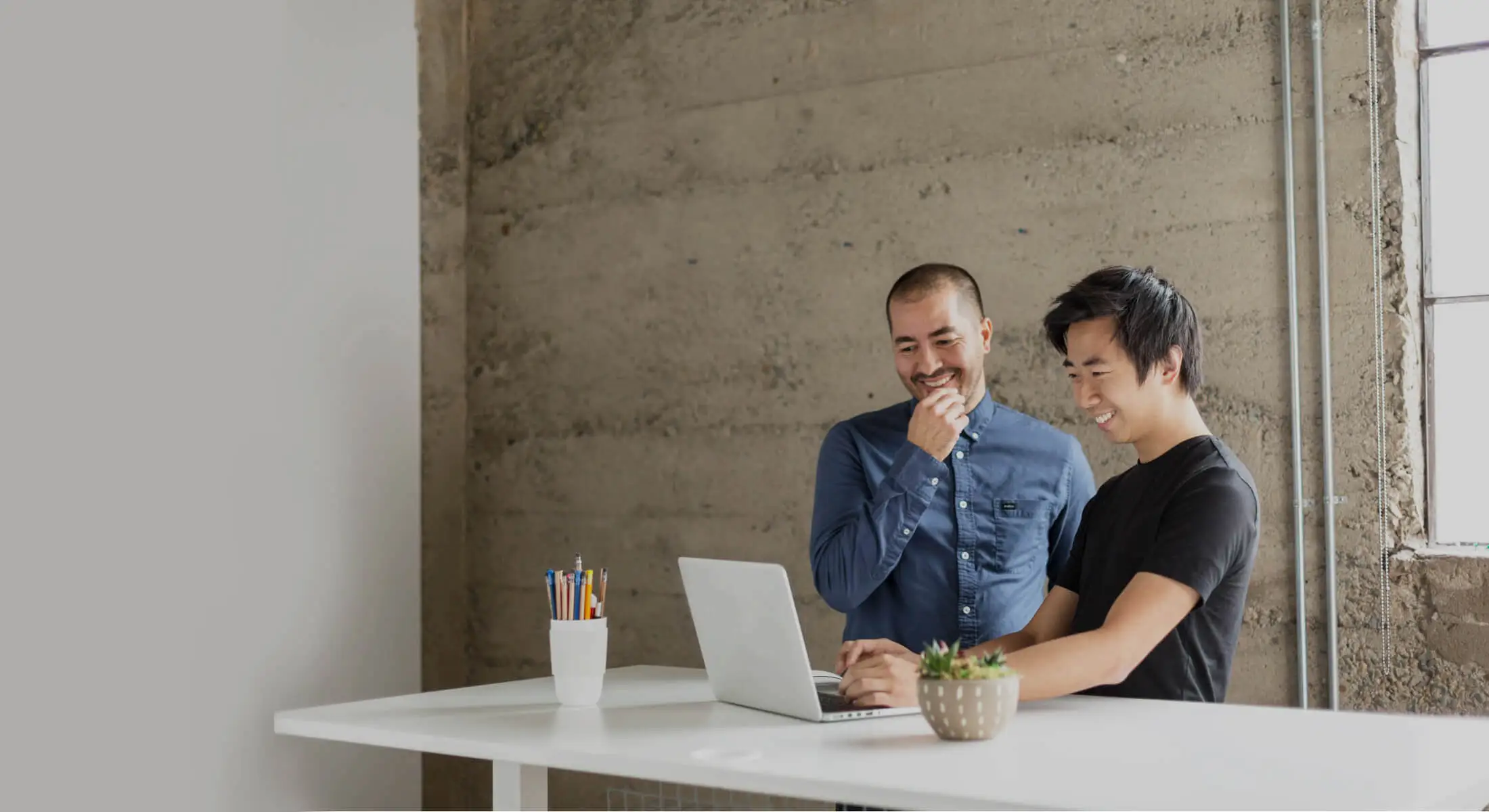 Two Men Smiling with Laptop