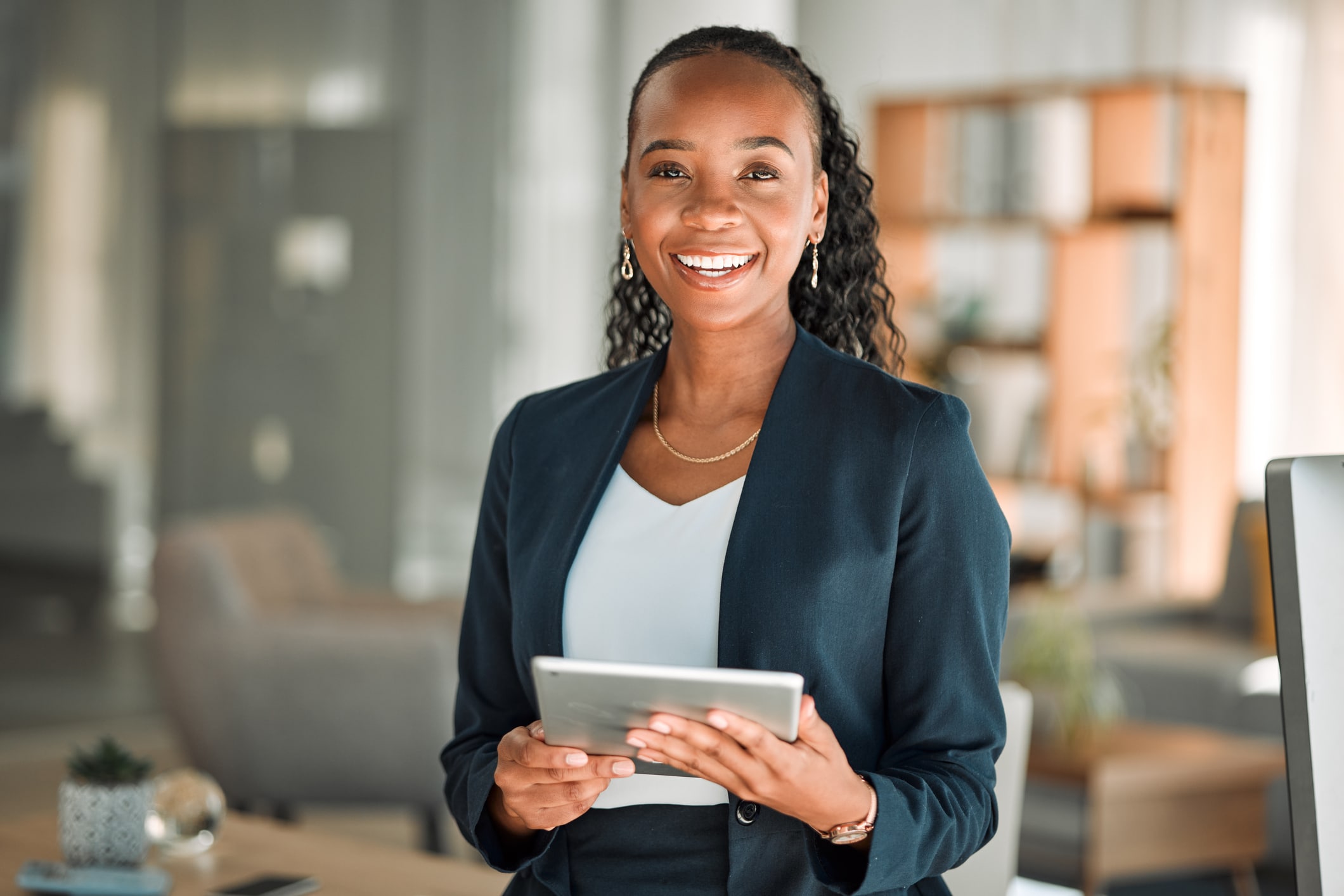 Woman with tablet, smiling and happy in office workplace
