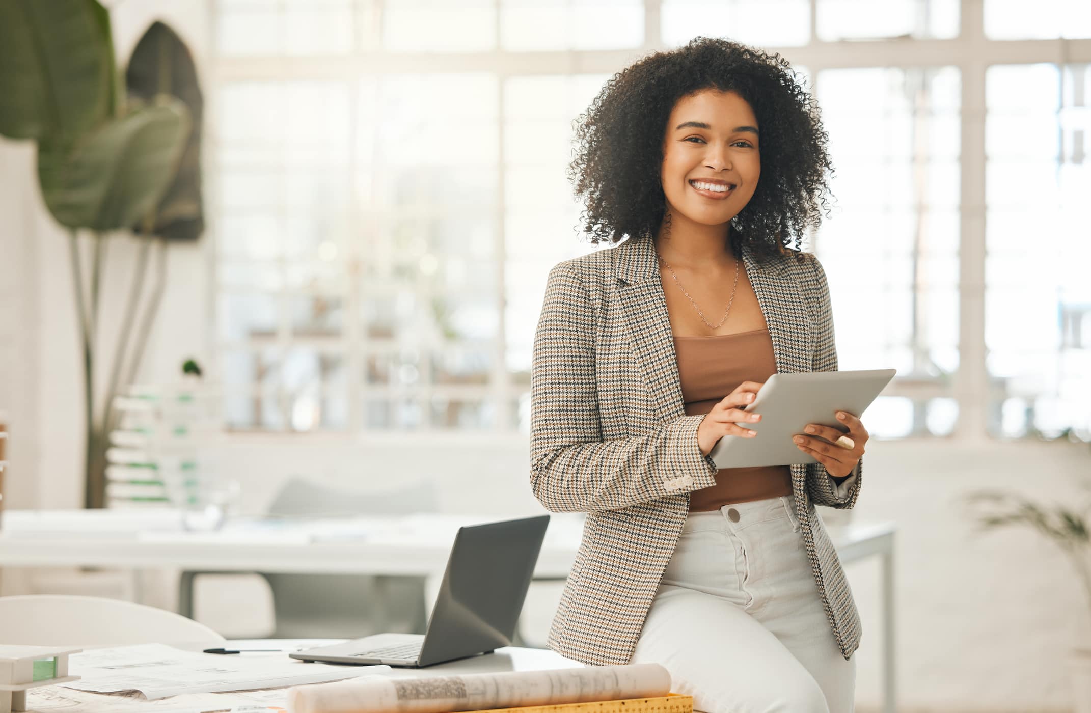 Businessperson smiling and using a digital tablet