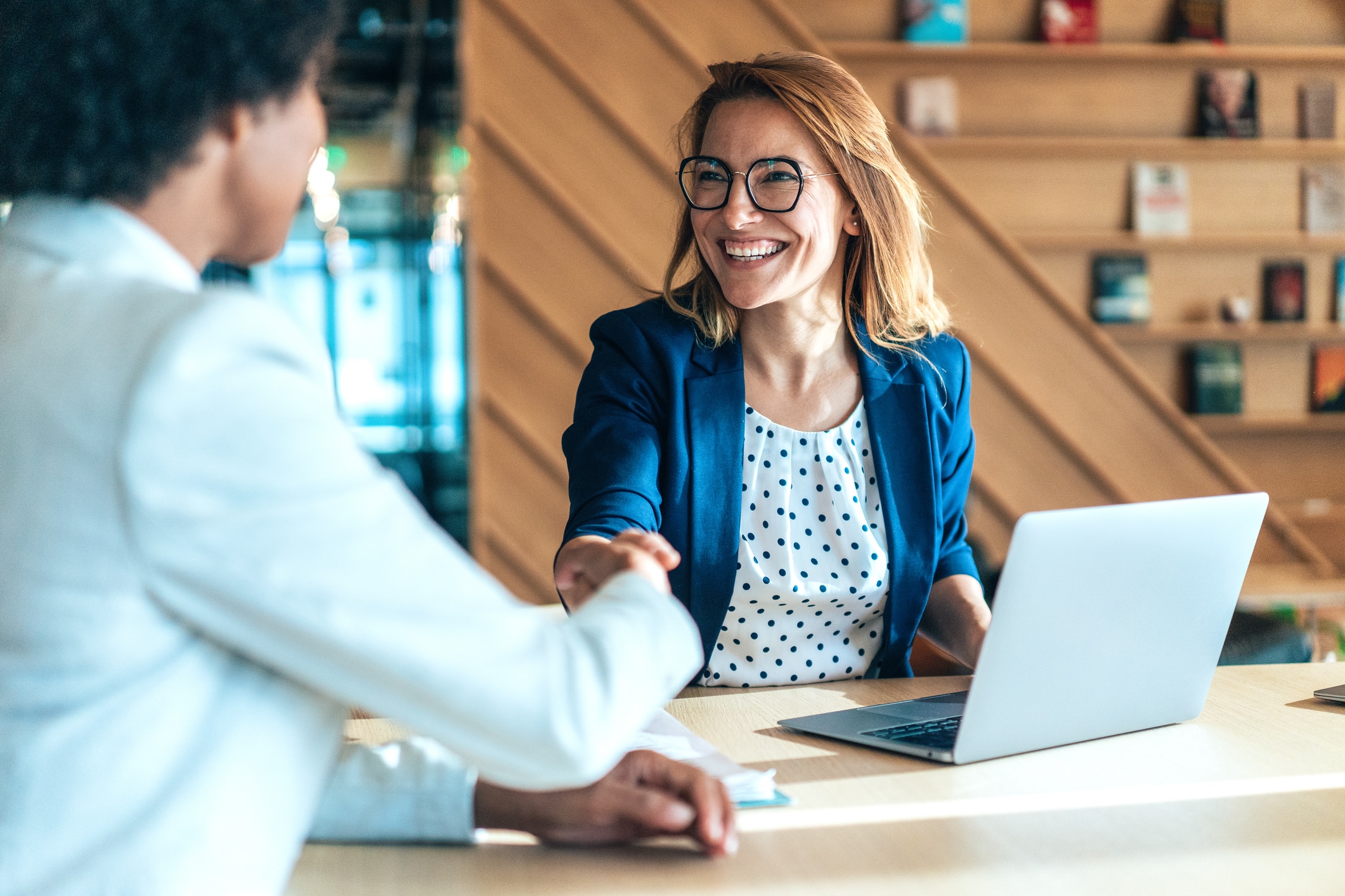 Business people shaking hands in an office setting