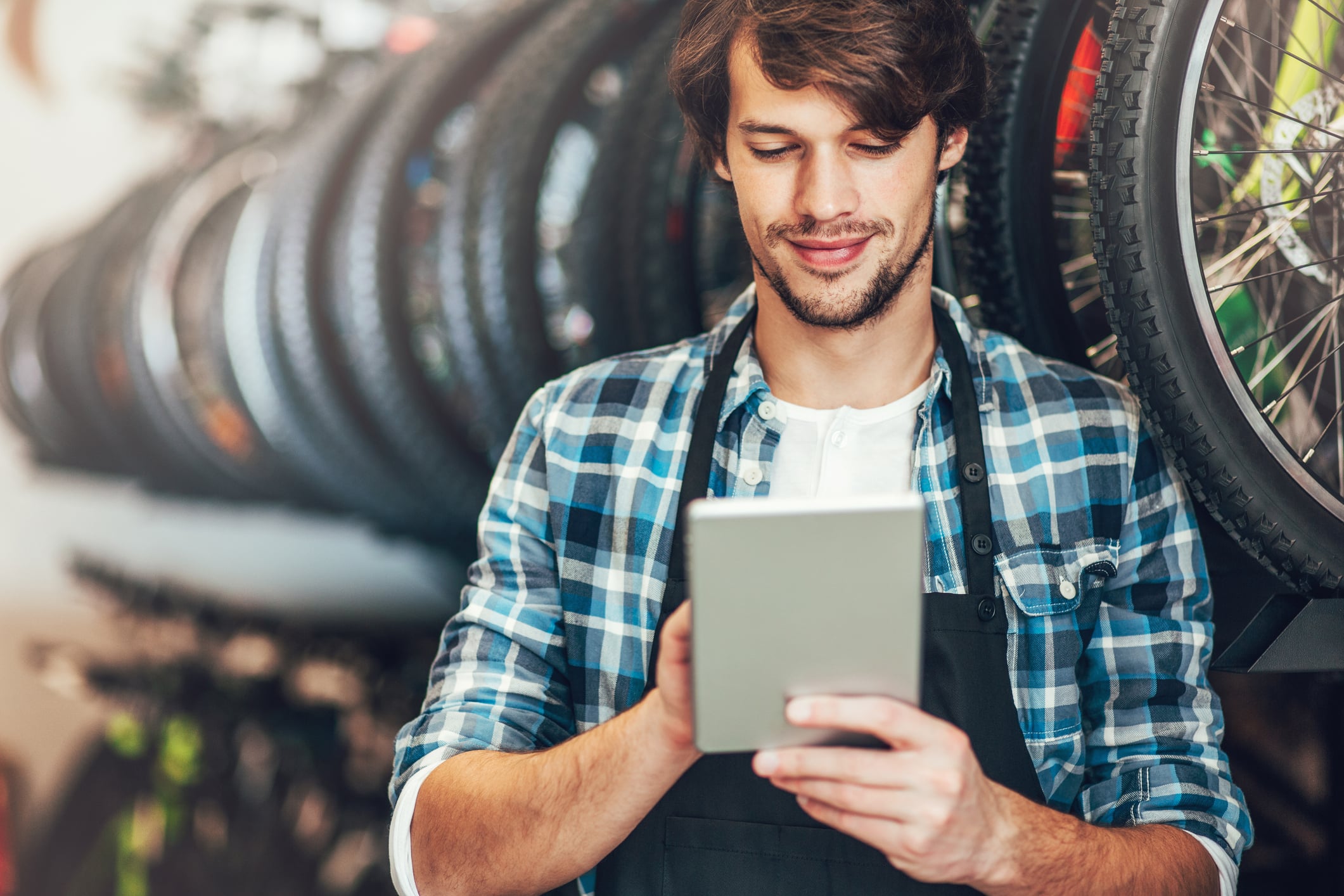 Person working on a tablet in a bike shop