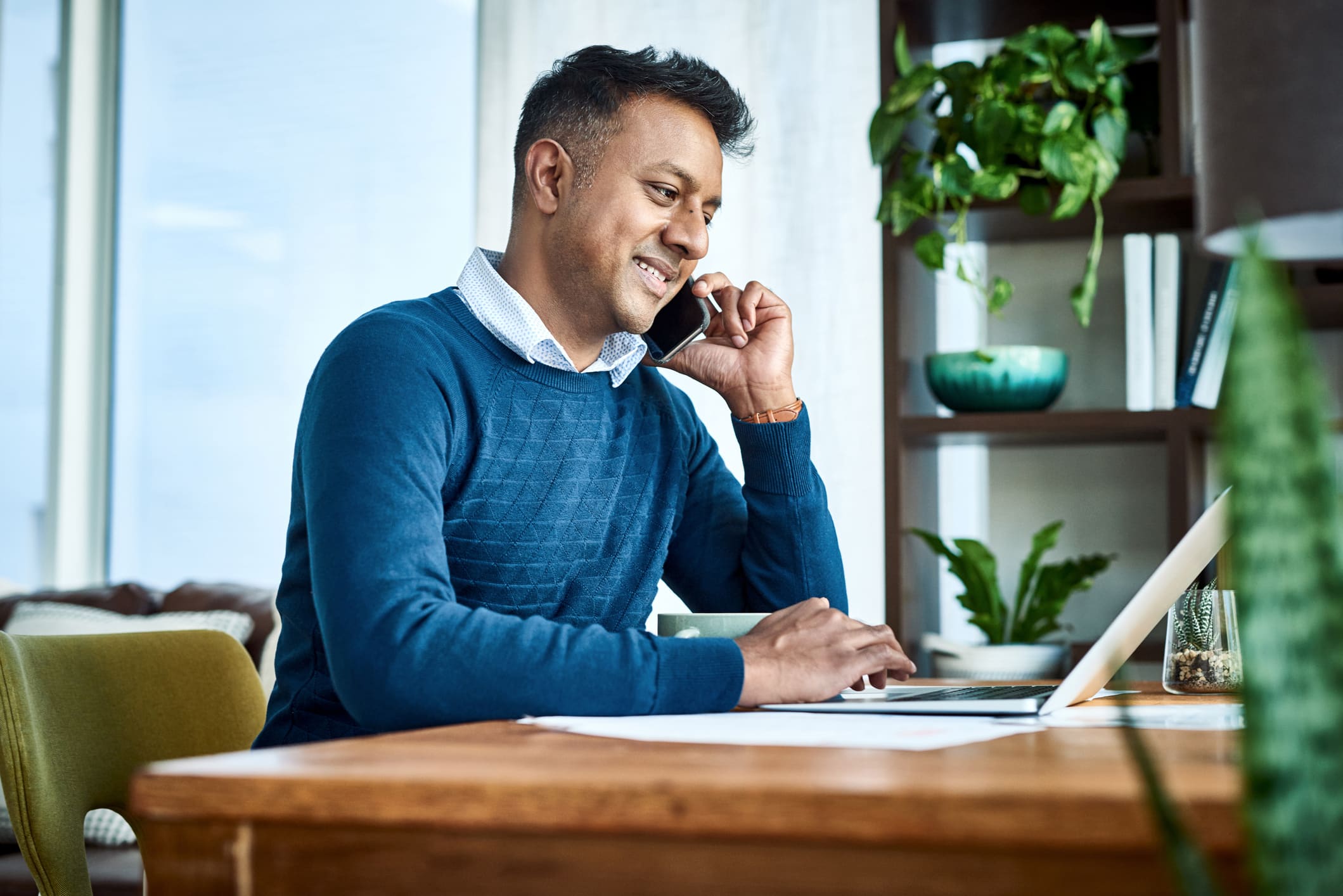 Shot of a person using a laptop and smartphone