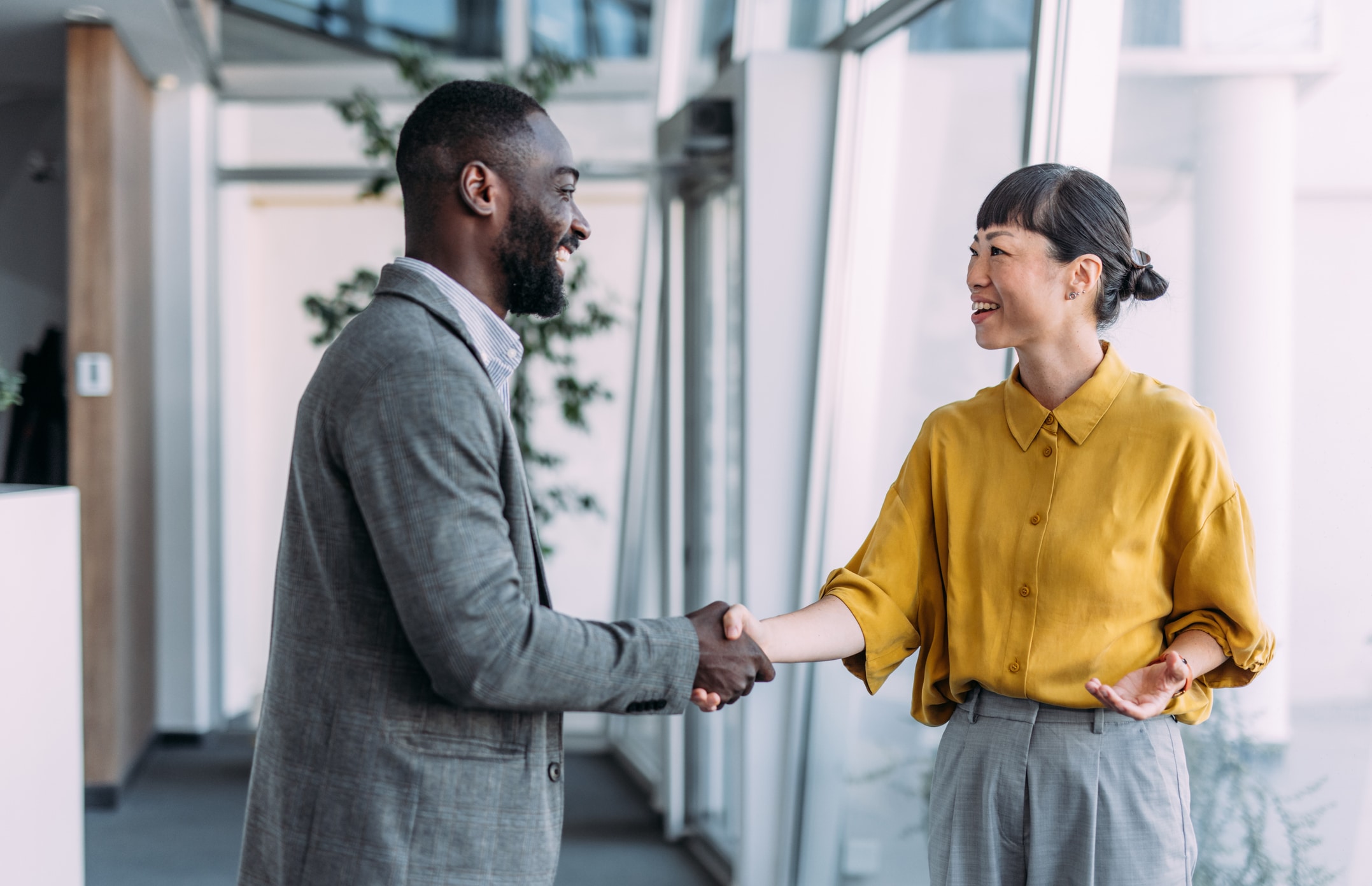 Colleagues shaking hands in the office.