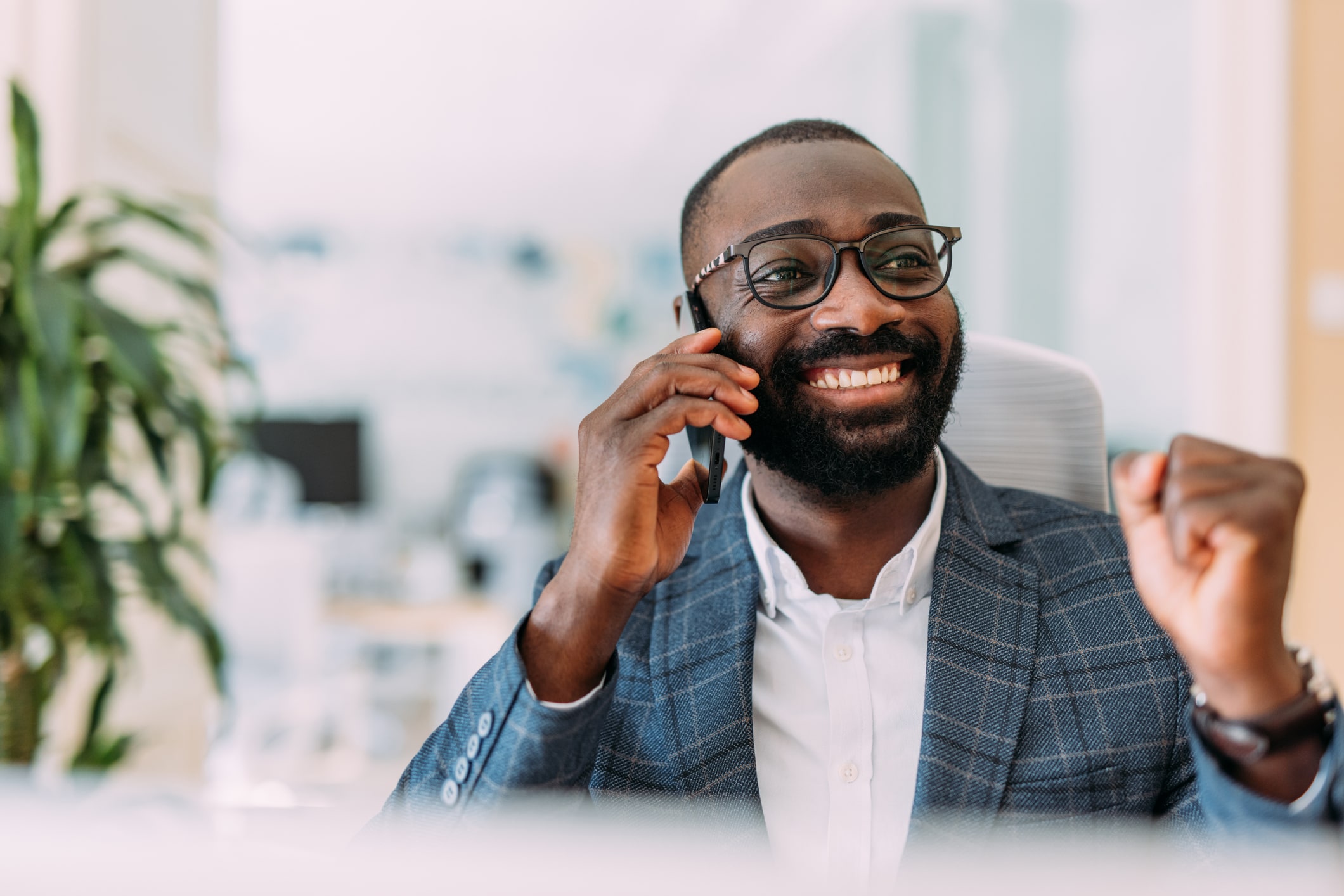 Businessperson talking on a phone in an office