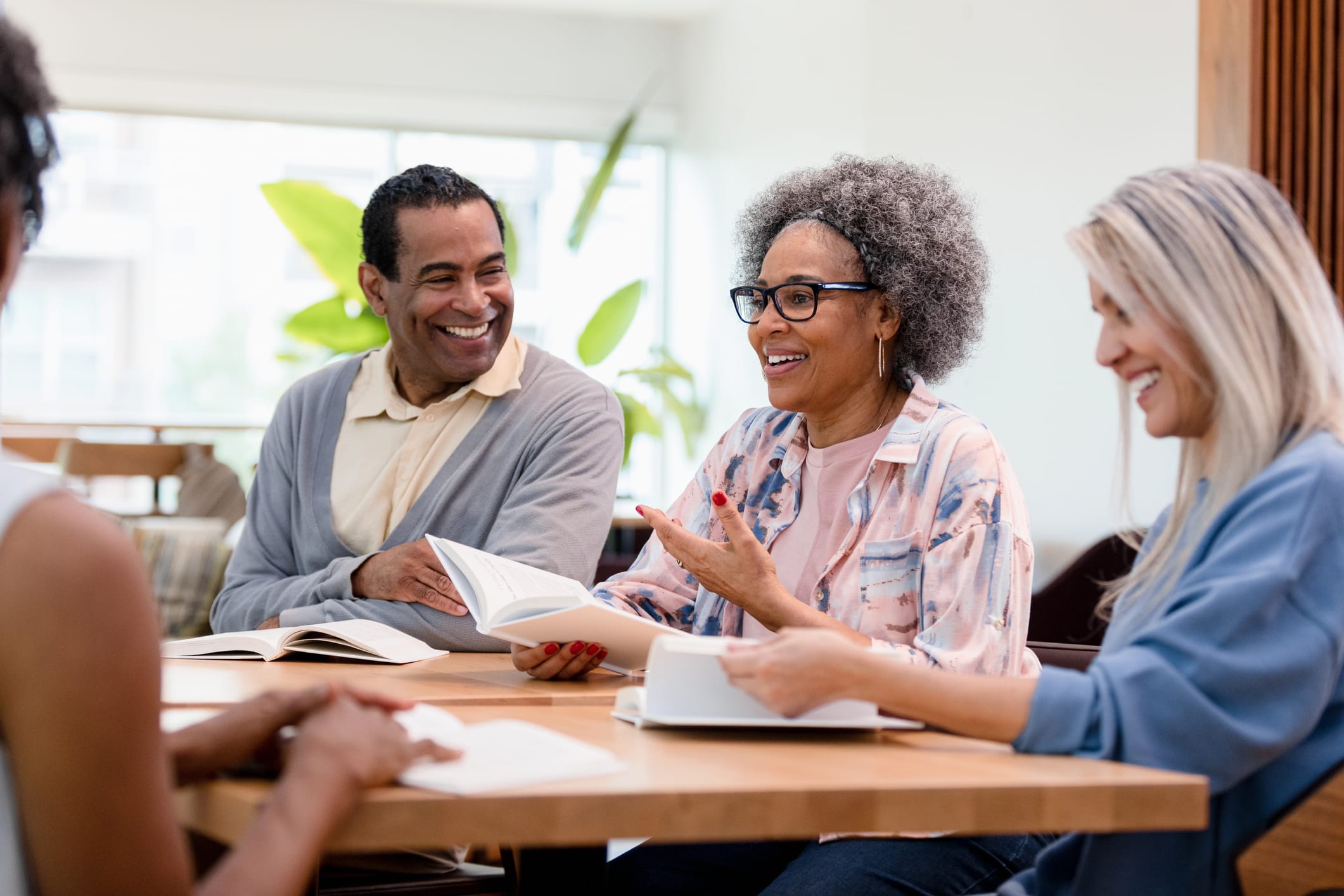 A person discusses a book with a group of people