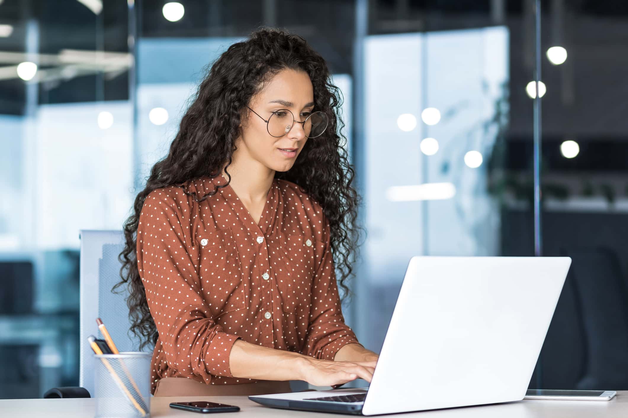 Person working on a laptop in an office setting