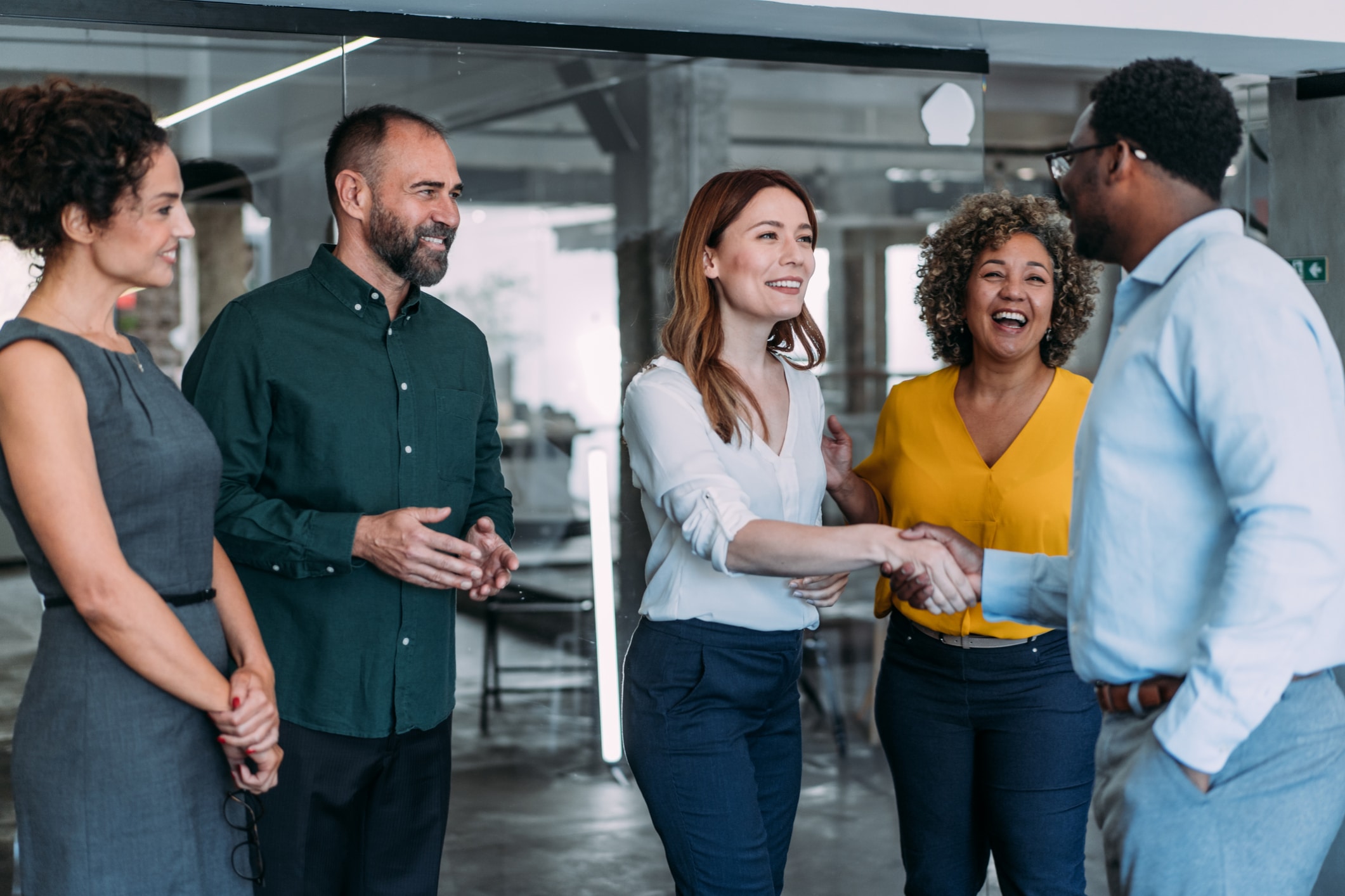 Business people shaking hands in an office setting